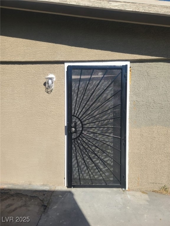 Property entrance featuring stucco siding
