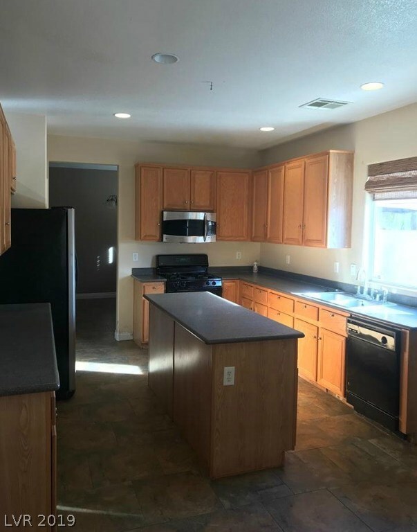 KITCHEN WITH PANTRY AND LOTS OF CABINET SPACE! ROOM FOR A TABLE AND CHAIRS IN KITCHEN, SLIDING DOORS TO BACK PATIO. ALL APPLIANCES INCLUDED AS IS.