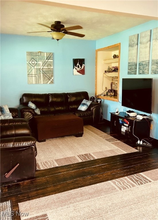 Living room featuring ceiling fan and wood finished floors