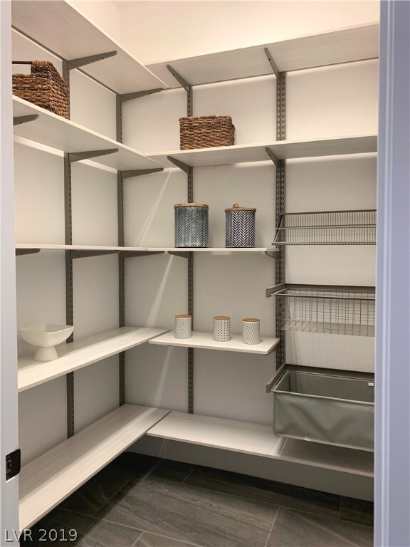 Walk-In Pantry is full of shelves.  Plenty of stor