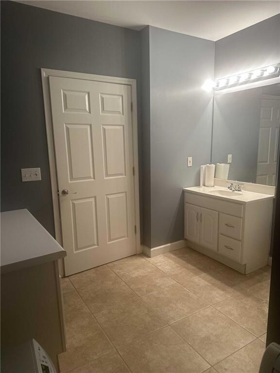 Bathroom with tile patterned flooring, vanity, and