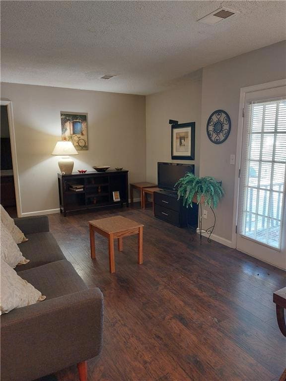 Living area featuring wood finished floors, a text