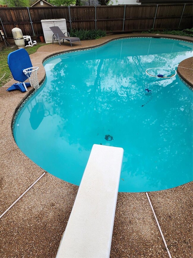 View of swimming pool with fence and a diving pool