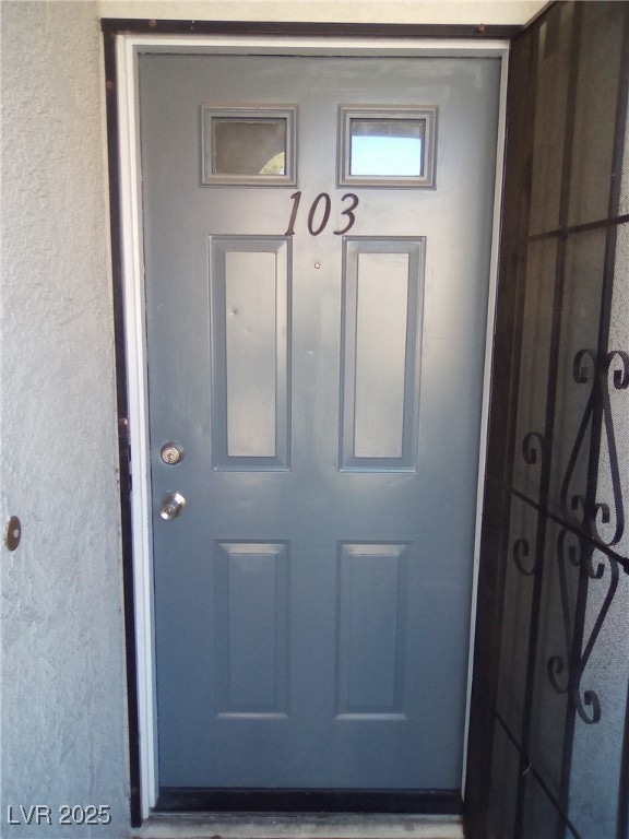 View of exterior entry with stucco siding