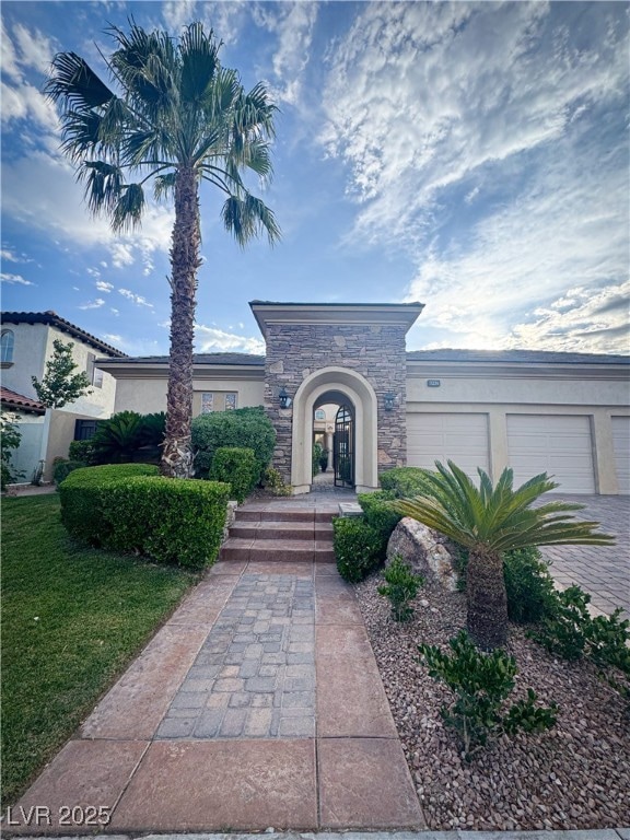 View of front of home with stone siding, stucco si