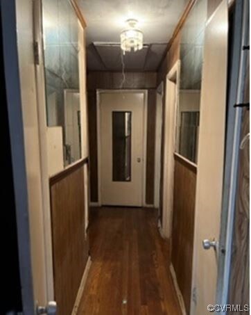 Hall featuring dark hardwood flooring.