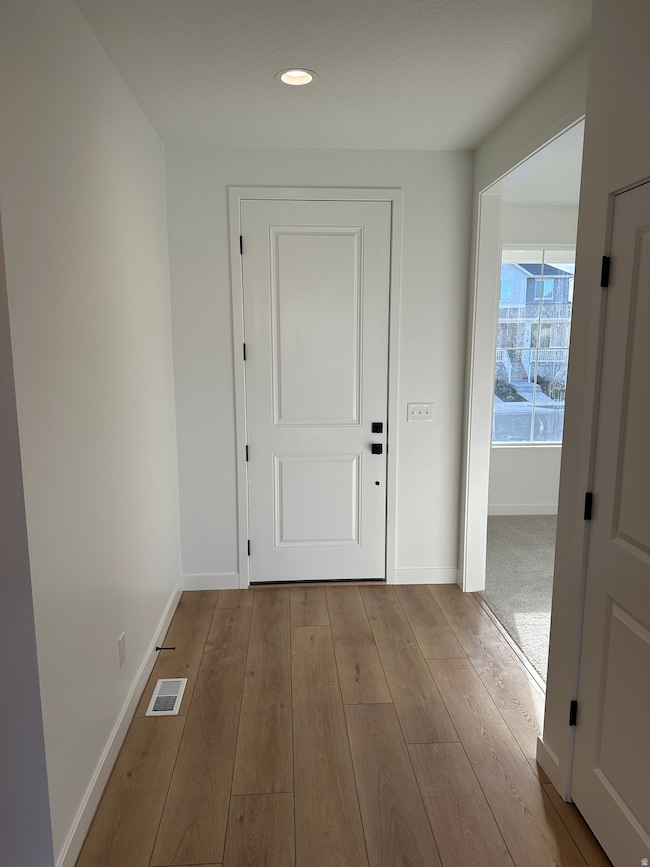 Entry featuring 8' front door with front room off to the side.