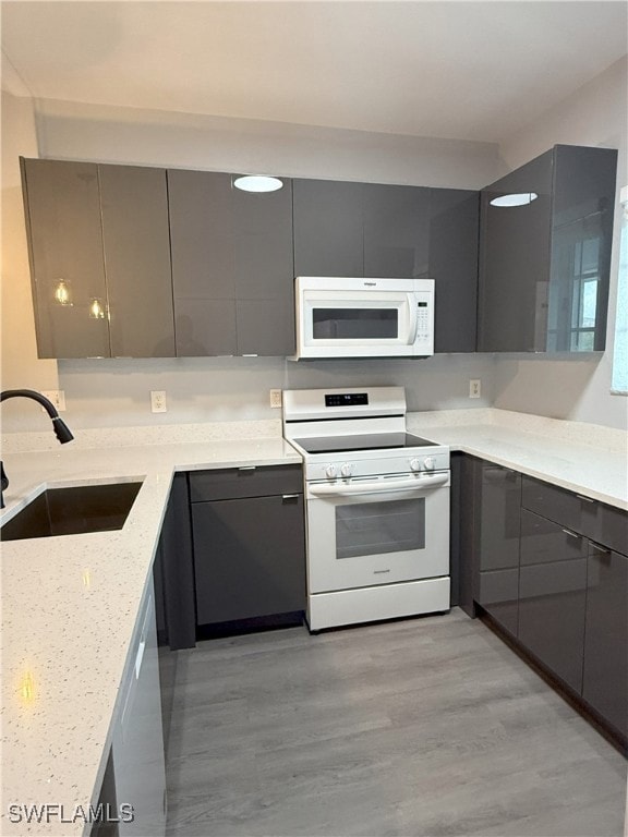 Kitchen with white appliances, a sink, modern cabi