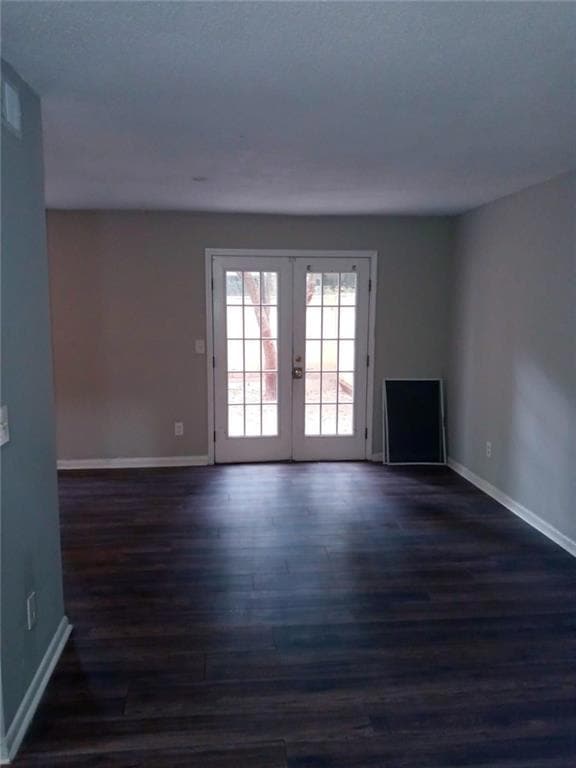 Unfurnished living room with french doors and dark