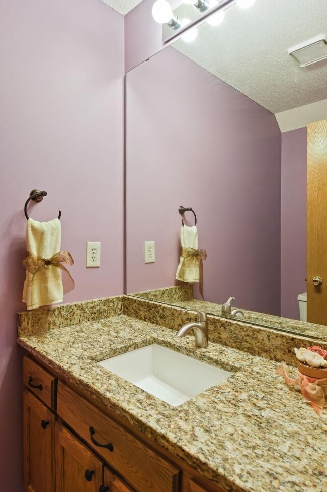 Main floor 1/2 bath with granite counter vanity.