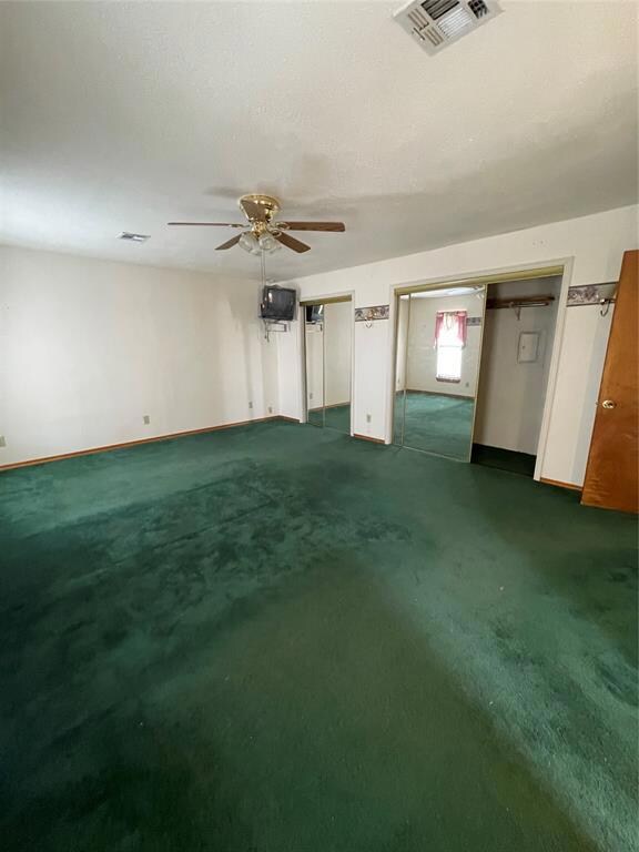 Second view of primary bedroom with a large closet