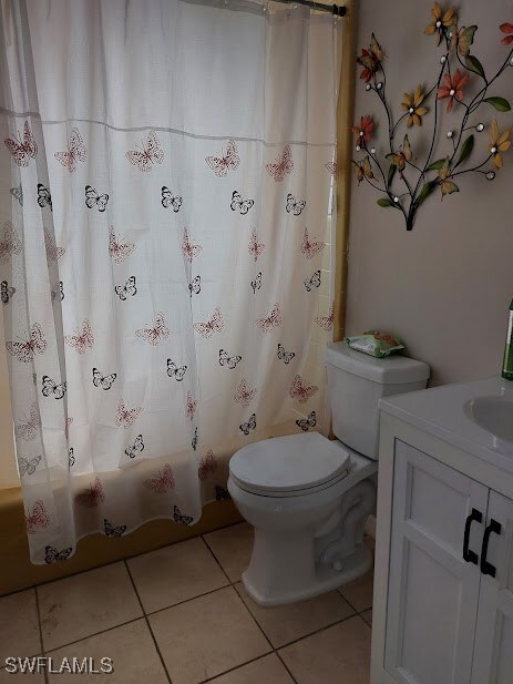 Full bathroom featuring tile patterned floors, toi