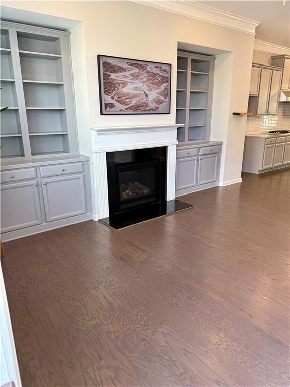 Living room with fireplace and built in shelving and cabinetry.