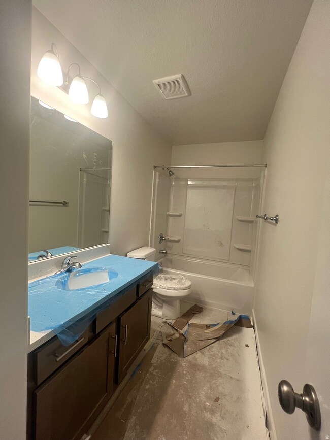 Full bath featuring vanity and  shower combination