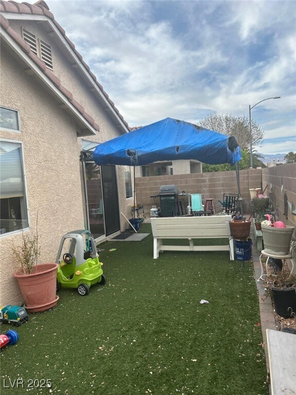 View of yard with a fenced backyard