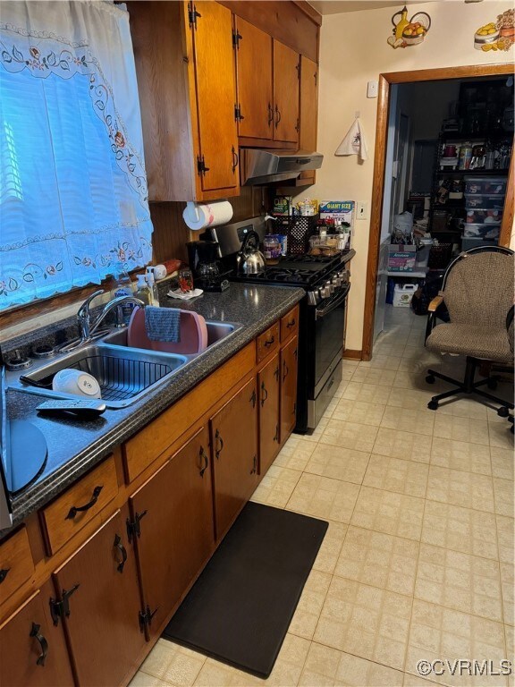 Kitchen with range hood and stainless steel stove