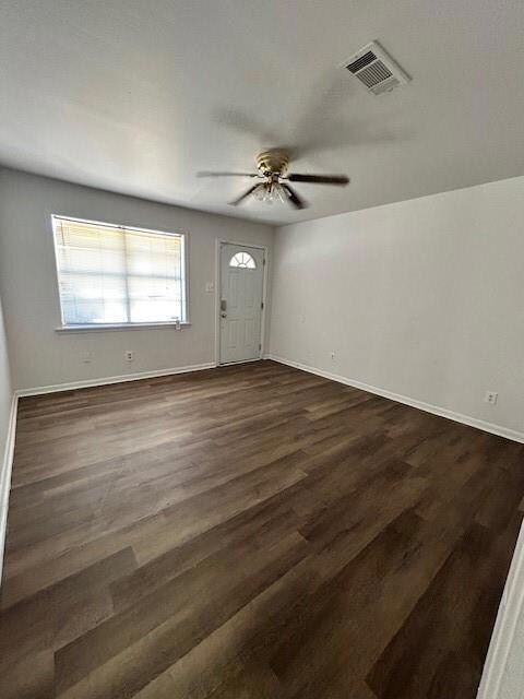 Entryway featuring ceiling fan and dark wood-type 