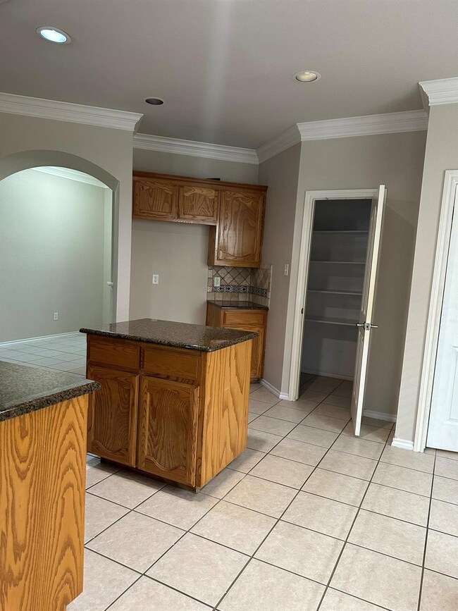 Kitchen with light tile patterned flooring, tastef