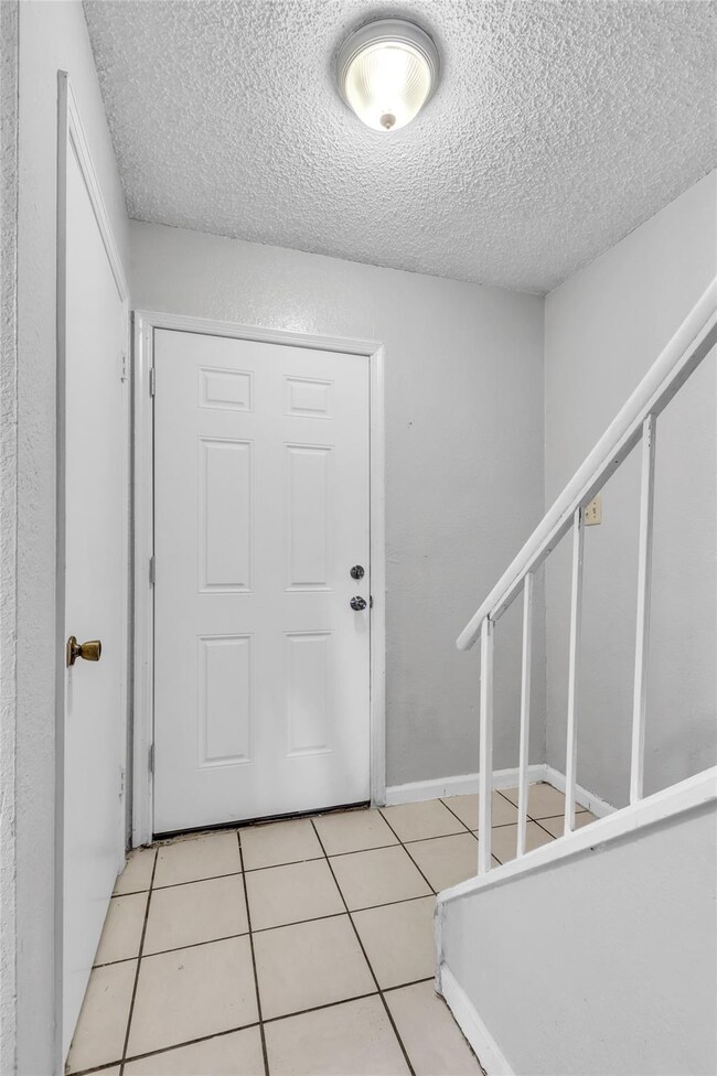 Entryway featuring light tile patterned flooring a