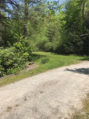 Gravel drive across bridge over clear flowing cree