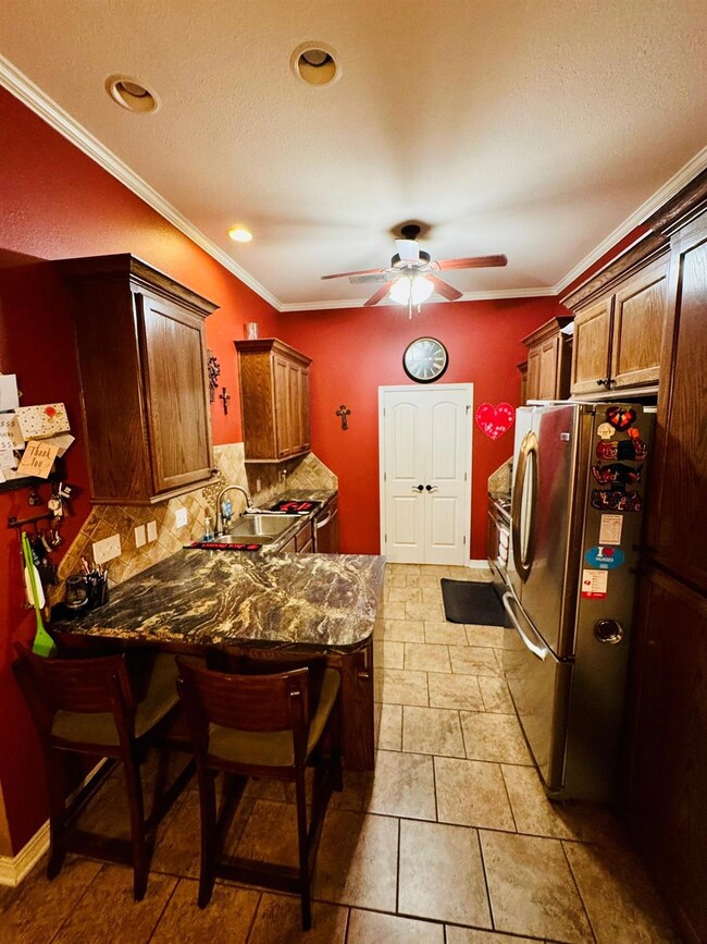 Kitchen featuring sink, stainless steel refrigerat