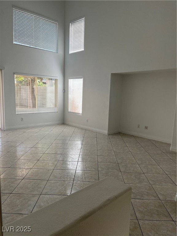 Empty room featuring tile patterned flooring, base