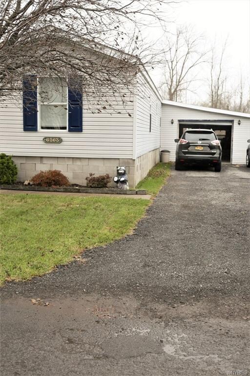 Front showing attached garage.