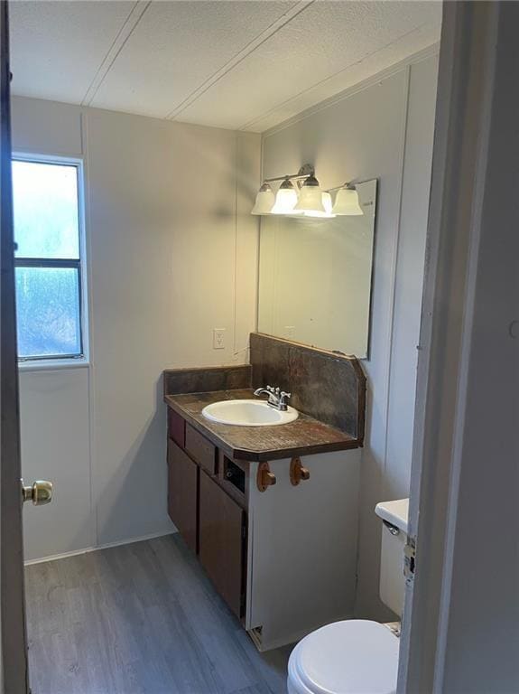 Half bath with vanity and light wood-style floors