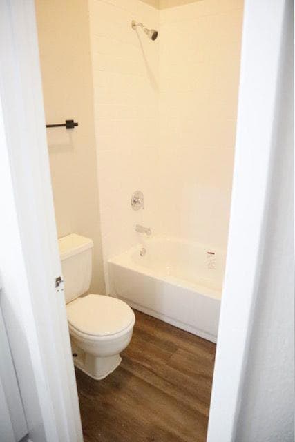 Bathroom featuring toilet, wood finished floors, 