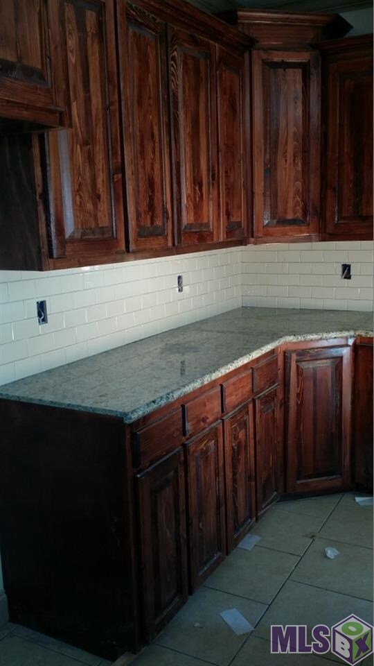 Gorgeous subway tile backsplash and stained wood c