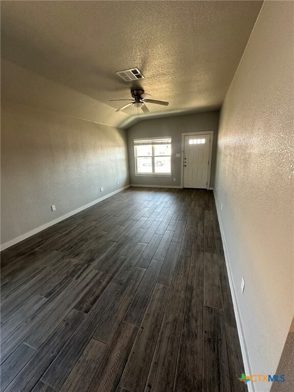 Large open living space with wood-look tile.