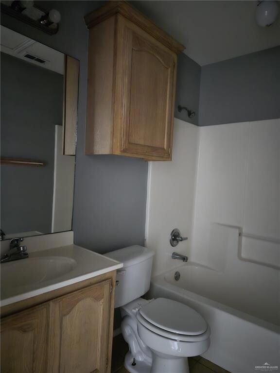 Full bathroom with bathtub / shower combination, vanity, and toilet