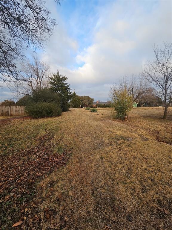 View of yard with a rural view