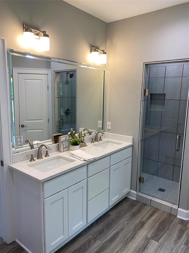 Bathroom with hardwood / wood-style floors, an enc