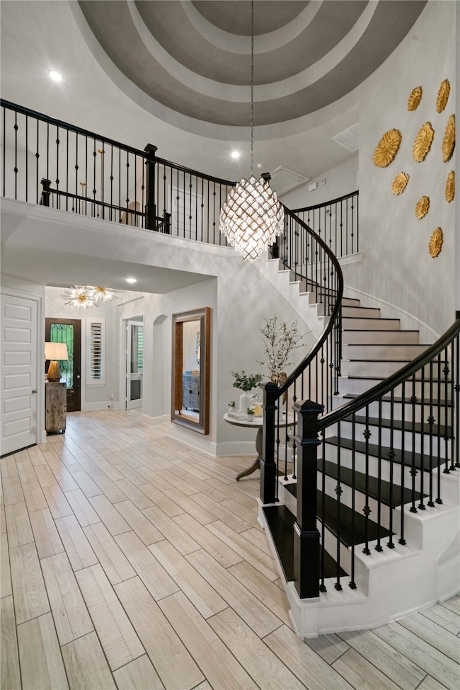 This elegant entryway features a grand, curved sta