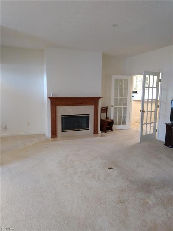 Living Room with gas fireplace and French doors le