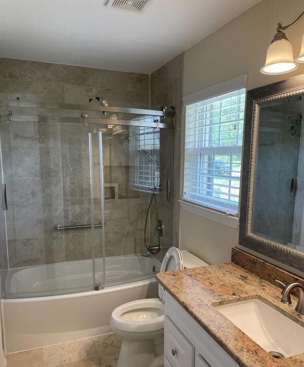 Full bathroom with vanity, combined bath / shower 