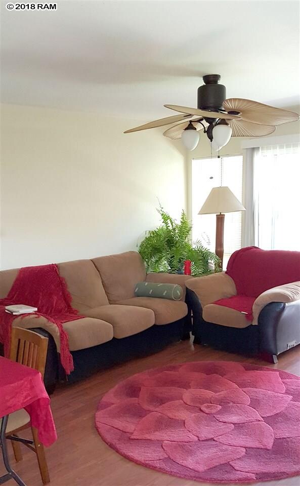 Wood laminate floors and custom ceiling fan.