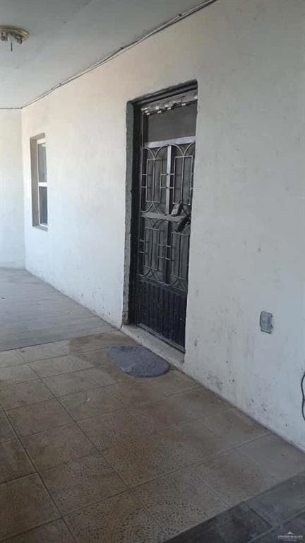 Entrance to property with stucco siding