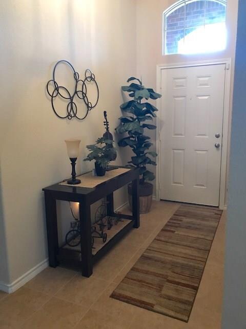Front door opens into a wide entry leading to open