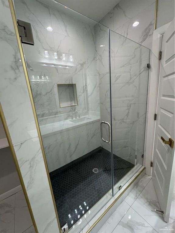 Bathroom featuring marble finish floor and a marble finish shower