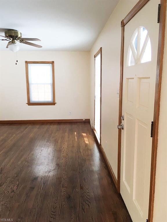 Front entry into the living room - refinished hardwood floor, ceiling fan, and an almost-to-the-floor front window lets in lots of light.