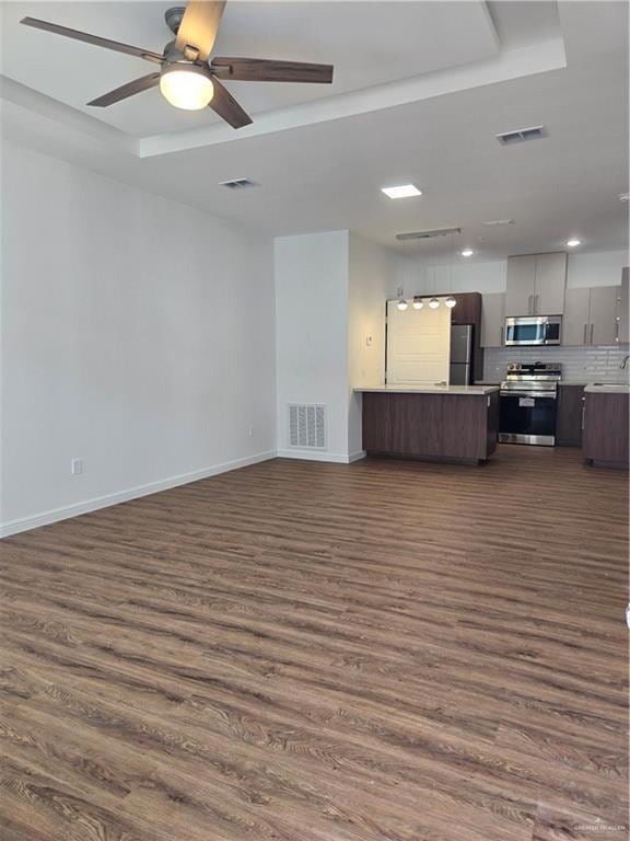 Unfurnished living room with dark wood-type flooring and visible vents