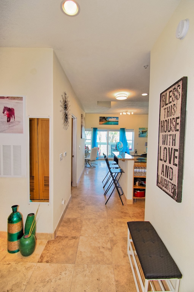 Welcoming entry hallway with tile flooring, leadin