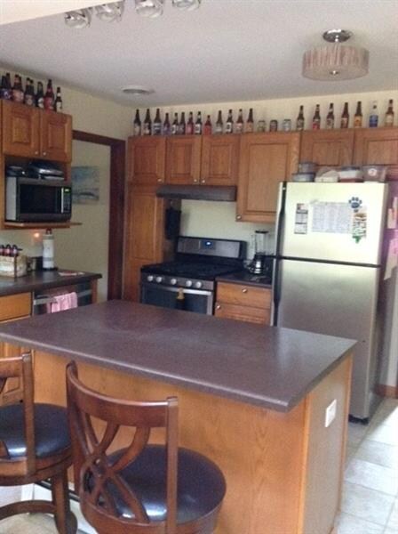 Kitchen with island for two. Stainless steel appli