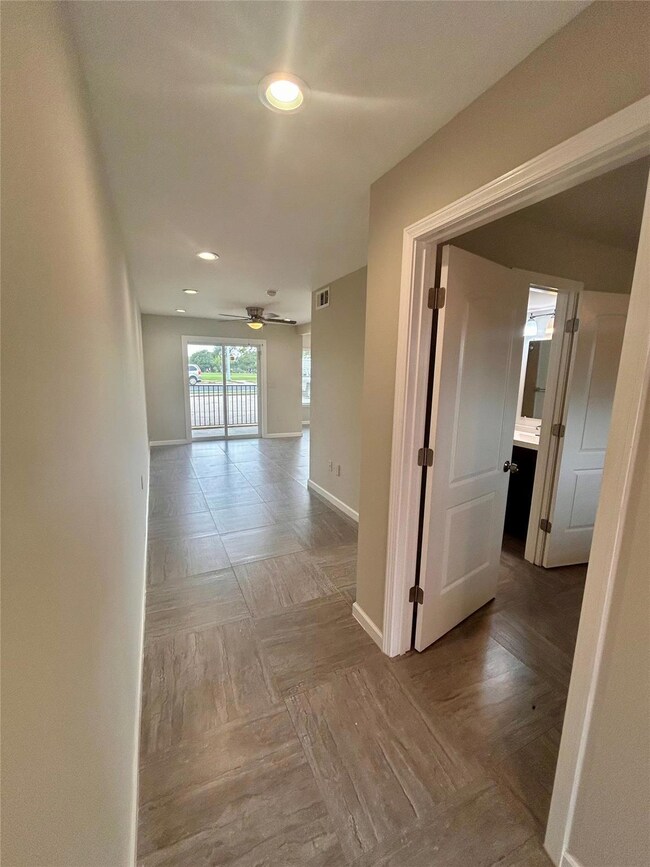Corridor with baseboards and recessed lighting