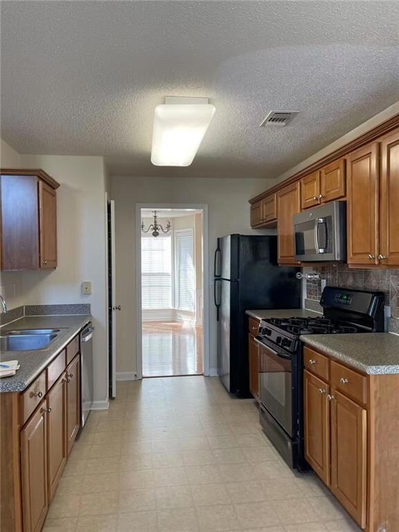 Kitchen featuring sink, decorative backsplash, and