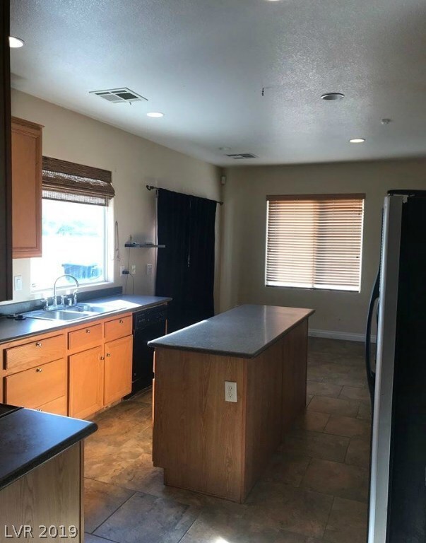 KITCHEN WITH PANTRY AND LOTS OF CABINET SPACE! ROOM FOR A TABLE AND CHAIRS IN KITCHEN, SLIDING DOORS TO BACK PATIO. ALL APPLIANCES INCLUDED AS IS.