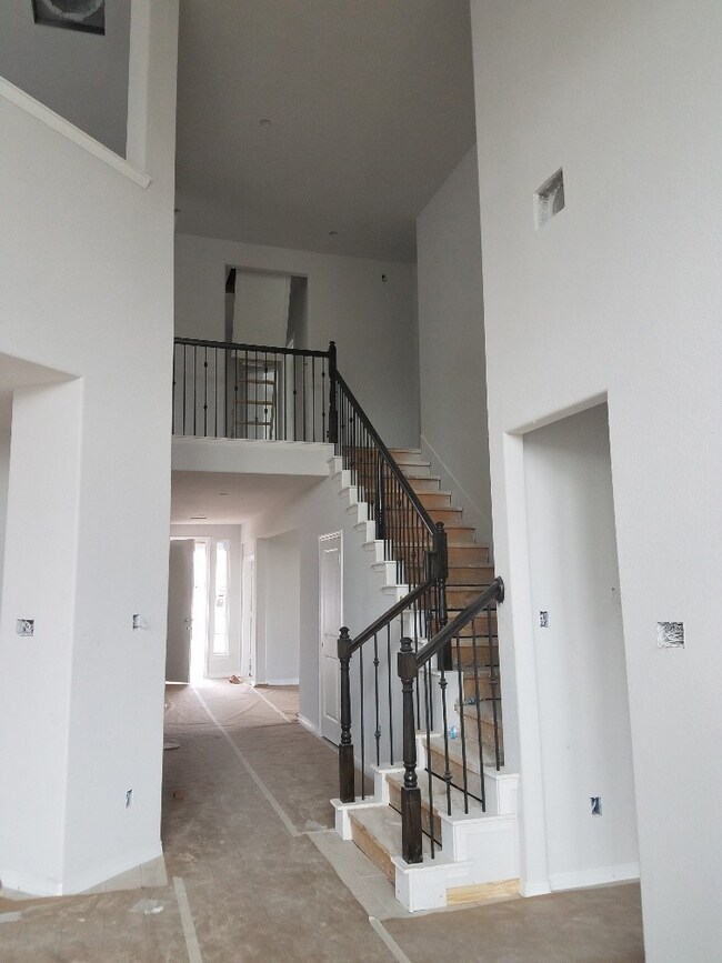 STAINED HAND RAILS AND IRON SPINDLES AT STAIRS
