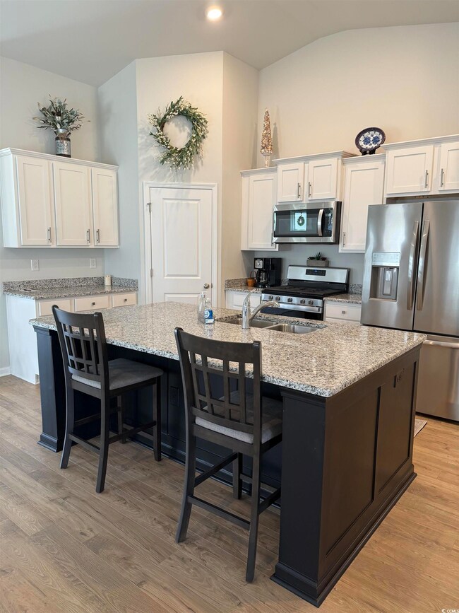 Kitchen with stainless steel appliances, white cab